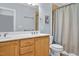 Bright bathroom with double sink vanity, framed mirror and tiled shower at 110 Tressel Way, Durham, NC 27707