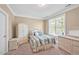 Charming bedroom furnished with wicker furniture and soft, patterned bedding, creating a cozy space at 110 Tressel Way, Durham, NC 27707
