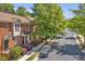 Charming brick townhome with well-manicured landscaping and a black car parked in front at 110 Tressel Way, Durham, NC 27707