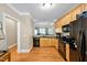 Modern kitchen features wood cabinets, sleek appliances and a view into the connected living space at 110 Tressel Way, Durham, NC 27707