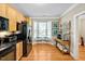 Bright kitchen featuring wood floors, wood cabinets and stainless appliances with a bay window at 110 Tressel Way, Durham, NC 27707