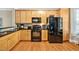 Cozy kitchen showcasing wood cabinets, granite countertops, and stainless steel appliances at 110 Tressel Way, Durham, NC 27707