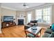 Relaxing living room featuring a fireplace, TV, and comfortable seating with natural light from the windows at 110 Tressel Way, Durham, NC 27707