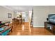 Spacious living room showcasing hardwood floors, an open layout, and access to dining and kitchen areas at 110 Tressel Way, Durham, NC 27707