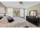 Bright bedroom with a large bed, black dresser, and neutral tones creating a calming atmosphere at 110 Tressel Way, Durham, NC 27707