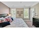 Serene bedroom featuring plush bedding, ample natural light, and coordinated decor for a relaxing retreat at 110 Tressel Way, Durham, NC 27707