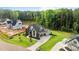 Aerial shot of a modern home with meticulously designed landscaping and a long driveway at 1108 Delilia Ln, Wake Forest, NC 27587