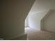 Attic space featuring an alcove, window, and a slanted ceiling with recessed lighting at 1108 Delilia Ln, Wake Forest, NC 27587