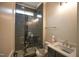 Modern bathroom with a sleek glass-enclosed shower and dark tiled accents at 1108 Delilia Ln, Wake Forest, NC 27587