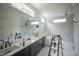 Bright primary bathroom with double vanity, large mirror, and walk-in shower at 1108 Delilia Ln, Wake Forest, NC 27587