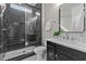 Modern bathroom with a glass shower, black tiling, vanity, and bright countertops at 1108 Delilia Ln, Wake Forest, NC 27587