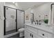 A modern bathroom featuring a glass shower with a rainfall showerhead, sleek vanity, and stylish black and white accents at 1108 Delilia Ln, Wake Forest, NC 27587
