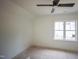 Bright, unfinished bedroom space featuring a large window, and modern ceiling fan at 1108 Delilia Ln, Wake Forest, NC 27587