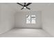 This bedroom features a ceiling fan, neutral carpet, and a window with natural light, creating a serene atmosphere at 1108 Delilia Ln, Wake Forest, NC 27587