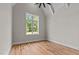 Bright bedroom with vaulted ceiling, large window with backyard views, and wooden floors at 1108 Delilia Ln, Wake Forest, NC 27587