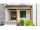 Inviting front entry with double doors, stone accents, and manicured landscaping at 1108 Delilia Ln, Wake Forest, NC 27587
