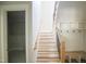 Bright entryway with wooden stairs, black iron railings, and built-in mudroom storage for organized living at 1108 Delilia Ln, Wake Forest, NC 27587