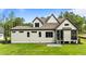 View of the house with white siding, dark trim, screened porch, and a well-maintained green lawn at 1108 Delilia Ln, Wake Forest, NC 27587