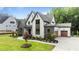 Beautiful exterior of a two-story home with stone and siding, plus landscaped front yard and driveway at 1108 Delilia Ln, Wake Forest, NC 27587