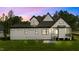 View of the house with white siding, dark trim, screened porch, and a well-maintained green lawn at 1108 Delilia Ln, Wake Forest, NC 27587