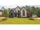Beautiful two-story home boasts a manicured lawn and a blend of stone and siding accents for striking curb appeal at 1108 Delilia Ln, Wake Forest, NC 27587