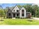 Stunning two-story home featuring stone accents, white siding, and a lush green lawn at 1108 Delilia Ln, Wake Forest, NC 27587