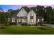 Stunning two-story home featuring stone accents, white siding, and a lush green lawn at 1108 Delilia Ln, Wake Forest, NC 27587