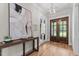 Elegant foyer featuring hardwood floors, stylish decor, and a view to glass French doors at 1108 Delilia Ln, Wake Forest, NC 27587