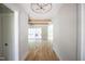 Bright hallway featuring hardwood floors, wooden beams, and an elegant chandelier at 1108 Delilia Ln, Wake Forest, NC 27587