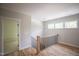Hallway featuring wood floors, railing, and natural light at 1108 Delilia Ln, Wake Forest, NC 27587
