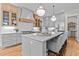 Bright kitchen featuring a large island with seating, stainless steel appliances, and custom cabinets at 1108 Delilia Ln, Wake Forest, NC 27587