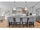 Spacious kitchen featuring a large island with seating, modern appliances, and hardwood floors at 1108 Delilia Ln, Wake Forest, NC 27587