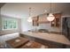 This kitchen features a large island, custom cabinetry, and modern lighting fixtures with hardwood floors at 1108 Delilia Ln, Wake Forest, NC 27587