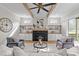 Bright living room with fireplace, wood beams, and built-in shelving surrounding the fireplace at 1108 Delilia Ln, Wake Forest, NC 27587