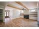 Open-concept living room featuring a fireplace, built-in shelving, and hardwood floors at 1108 Delilia Ln, Wake Forest, NC 27587