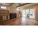 Bright living room with hardwood floors, a modern fireplace, and sliding glass doors to the back at 1108 Delilia Ln, Wake Forest, NC 27587