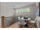 Upstairs loft area with staircase views, table with seating, and decorative lighting at 1108 Delilia Ln, Wake Forest, NC 27587