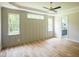 Bright main bedroom featuring ample natural light, a tray ceiling, and hardwood floors at 1108 Delilia Ln, Wake Forest, NC 27587