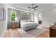 Tranquil bedroom with large windows, wood floors, and a view into a stunning en-suite bathroom at 1108 Delilia Ln, Wake Forest, NC 27587