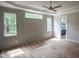 Sun-filled main bedroom with wainscoting detail, hardwood floors, and a ceiling fan at 1108 Delilia Ln, Wake Forest, NC 27587