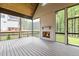 A screened porch with a fireplace, wood ceiling, and backyard views offers a relaxing outdoor living space at 1108 Delilia Ln, Wake Forest, NC 27587