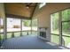 Vaulted screened porch with brick fireplace, ceiling fan, and views of the landscaped backyard at 1108 Delilia Ln, Wake Forest, NC 27587