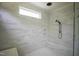 Stylish walk-in shower featuring white marble tile, a built-in bench, and modern fixtures at 1108 Delilia Ln, Wake Forest, NC 27587