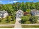 Aerial view of a well-maintained two-story home surrounded by lush trees and manicured landscaping at 1198 Shining Water Ln, Creedmoor, NC 27522