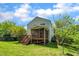 Backyard view showcasing a well-maintained lawn, spacious deck and screened-in porch at 1198 Shining Water Ln, Creedmoor, NC 27522