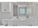 Bright bathroom with a double sink vanity and a marble-look shower at 1198 Shining Water Ln, Creedmoor, NC 27522