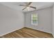 This is a small bedroom with wood look floors, a window and ceiling fan at 1198 Shining Water Ln, Creedmoor, NC 27522