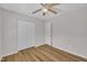 A bedroom with wood look floors, a ceiling fan, and a closet at 1198 Shining Water Ln, Creedmoor, NC 27522