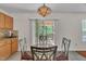 Dining Area features a glass top table and a decorative lighting fixture with sliding glass door access to deck at 1198 Shining Water Ln, Creedmoor, NC 27522
