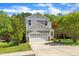 Attractive two-story home showcasing a two-car garage, well-kept lawn, and complementary landscaping at 1198 Shining Water Ln, Creedmoor, NC 27522
